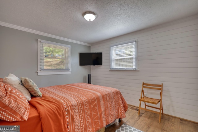 480 Friar Tuck Cir, Covington, GA 30014 - bedroom with a textured ceiling, wood finished floors, ornamental molding, and multiple windows