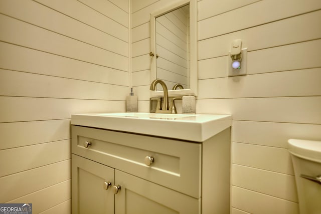 480 Friar Tuck Cir, Covington, GA 30014 - half bath featuring toilet, vanity, and wooden walls