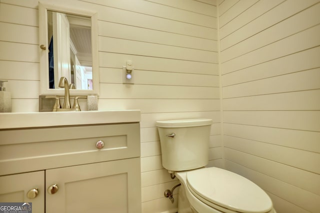 480 Friar Tuck Cir, Covington, GA 30014 - half bathroom with toilet, wood walls, and vanity