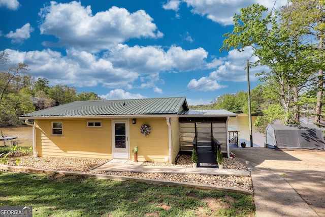 480 Friar Tuck Cir, Covington, GA 30014 - back of property featuring metal roof and concrete driveway