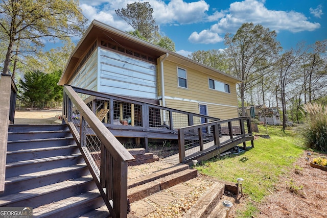 480 Friar Tuck Cir, Covington, GA 30014 - rear view of house with stairway, a wooden deck, and a lawn