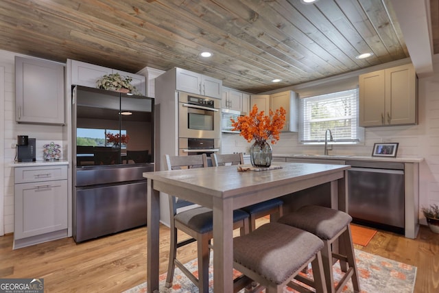 480 Friar Tuck Cir, Covington, GA 30014 - kitchen featuring light wood-type flooring, recessed lighting, wood ceiling, appliances with stainless steel finishes, and light countertops