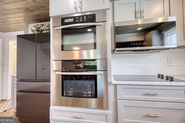 480 Friar Tuck Cir, Covington, GA 30014 - kitchen featuring wood walls, light stone countertops, and stainless steel appliances