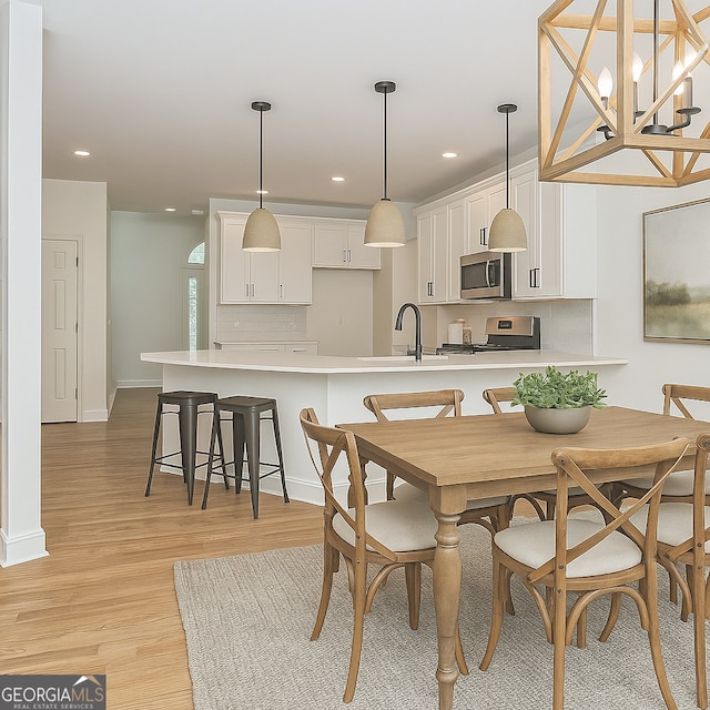 8660 Anchor On Lanier Ct, Gainesville, GA 30506 - dining area featuring light wood-style floors, recessed lighting, baseboards, and a chandelier