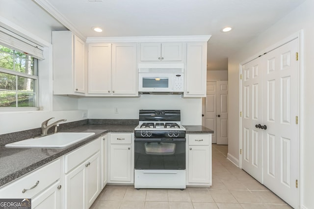 8660 Anchor On Lanier Ct, Gainesville, GA 30506 - kitchen with white microwave, gas range oven, a sink, light tile patterned floors, and dark countertops