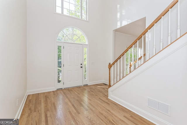 8660 Anchor On Lanier Ct, Gainesville, GA 30506 - entryway featuring a towering ceiling, stairway, wood finished floors, and baseboards
