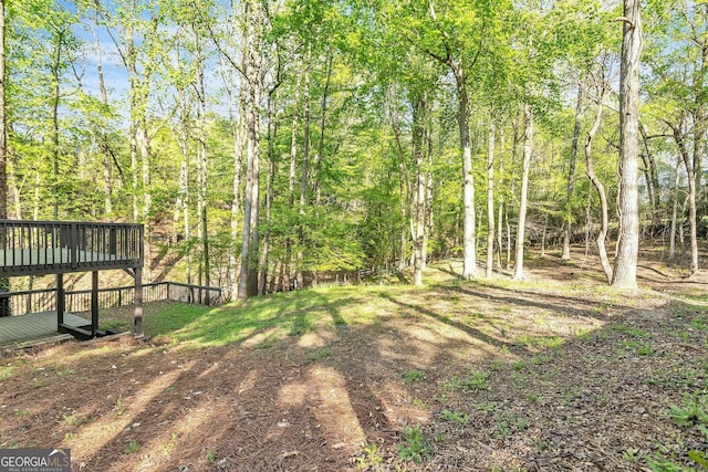 8660 Anchor On Lanier Ct, Gainesville, GA 30506 - view of yard with a wooden deck and a view of trees