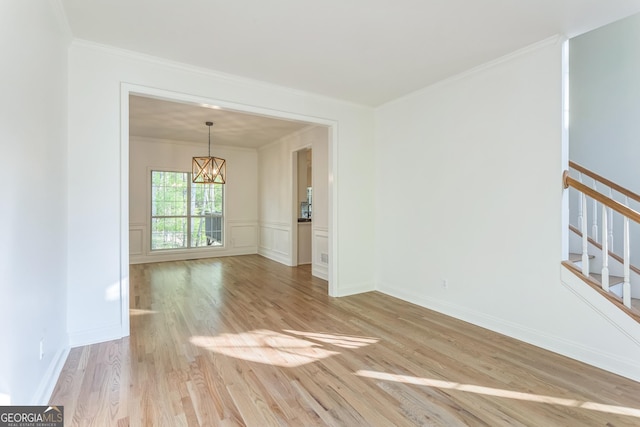 8660 Anchor On Lanier Ct, Gainesville, GA 30506 - empty room featuring a chandelier, crown molding, light wood-style flooring, and stairway