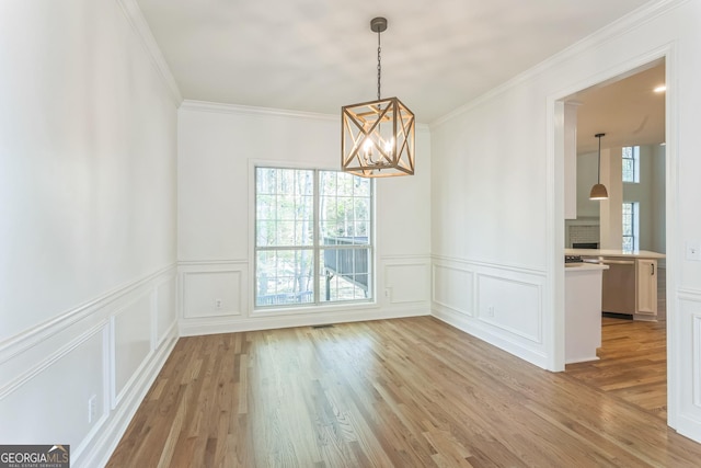 8660 Anchor On Lanier Ct, Gainesville, GA 30506 - unfurnished dining area featuring a chandelier, light wood finished floors, ornamental molding, a decorative wall, and a wainscoted wall