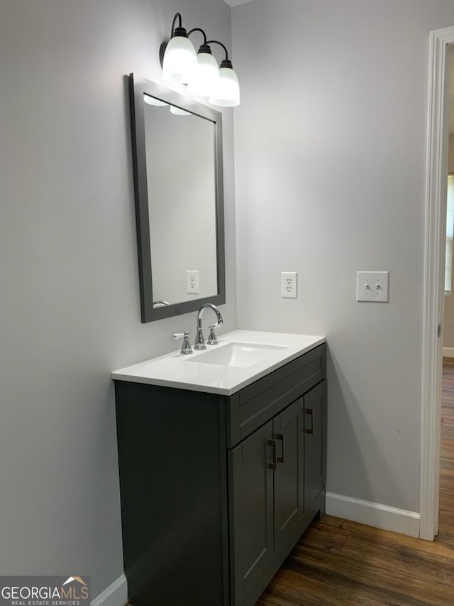 2467 Shady Grove Rd, Carrollton, GA 30116 - bathroom with baseboards, wood finished floors, and vanity
