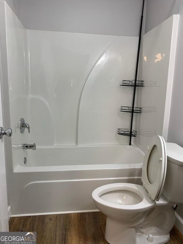 2467 Shady Grove Rd, Carrollton, GA 30116 - bathroom featuring toilet, bathing tub / shower combination, and wood finished floors