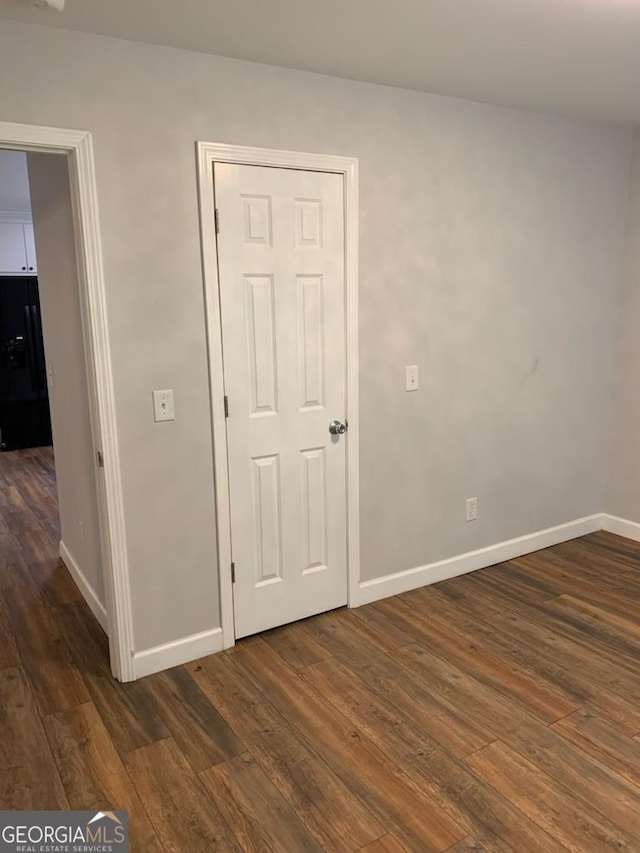 2467 Shady Grove Rd, Carrollton, GA 30116 - spare room featuring dark wood-style floors and baseboards