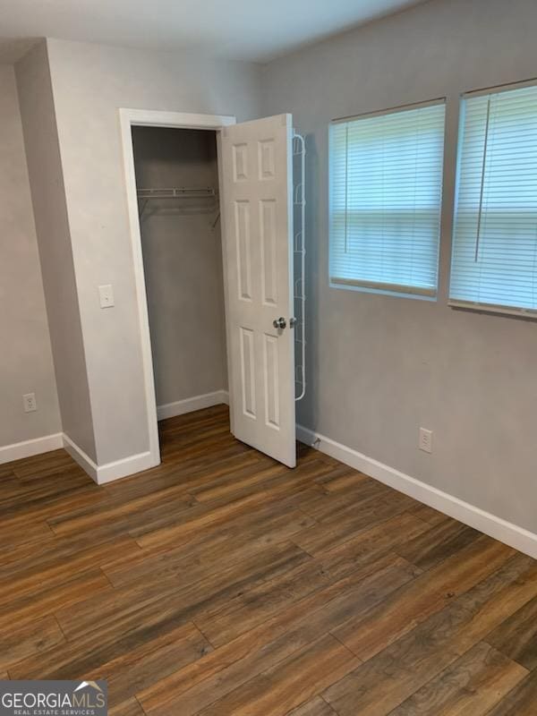 2467 Shady Grove Rd, Carrollton, GA 30116 - unfurnished bedroom featuring baseboards, wood finished floors, and a closet