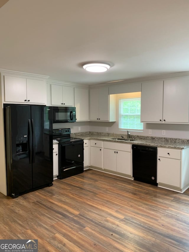 2467 Shady Grove Rd, Carrollton, GA 30116 - kitchen featuring black appliances, a sink, white cabinetry, and dark wood-style floors