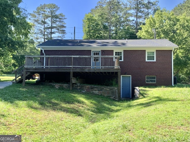 2467 Shady Grove Rd, Carrollton, GA 30116 - rear view of house featuring a deck, a lawn, brick siding, and stairway