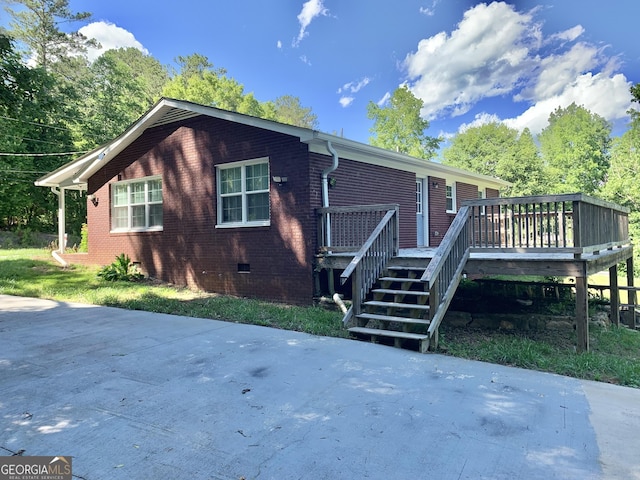 2467 Shady Grove Rd, Carrollton, GA 30116 - view of side of property with a deck, brick siding, crawl space, and stairway
