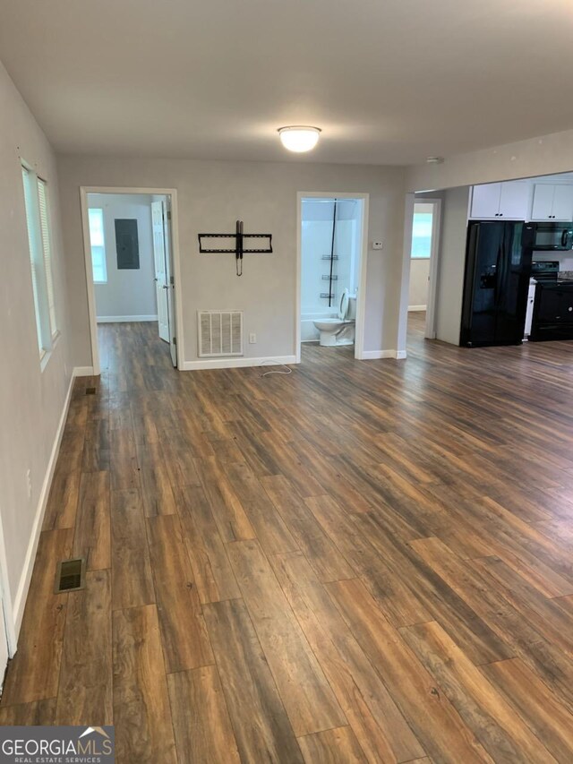 2467 Shady Grove Rd, Carrollton, GA 30116 - unfurnished living room with dark wood-style floors, baseboards, and plenty of natural light