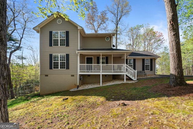 view of front facade featuring a front yard, a porch, fence, and crawl space