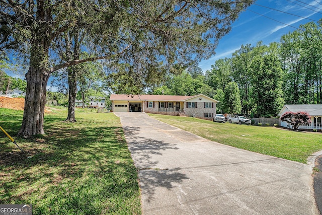 single story home with driveway, a front yard, and a garage