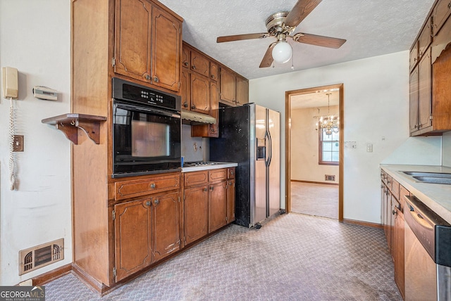 kitchen featuring oven, visible vents, ceiling fan with notable chandelier, dishwasher, and refrigerator with ice dispenser