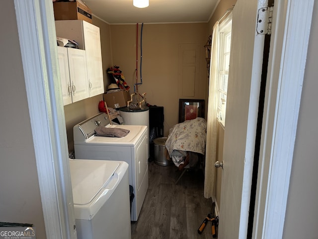 washroom featuring washing machine and clothes dryer, dark wood-style floors, and cabinet space