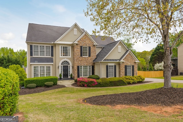 2635 Stonehill Dr, Cumming, GA 30041 - view of front of home with fence, stone siding, a standing seam roof, and stucco siding