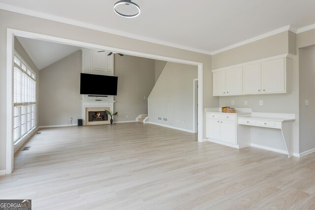 2635 Stonehill Dr, Cumming, GA 30041 - unfurnished living room with visible vents, baseboards, light wood finished floors, stairs, and a lit fireplace