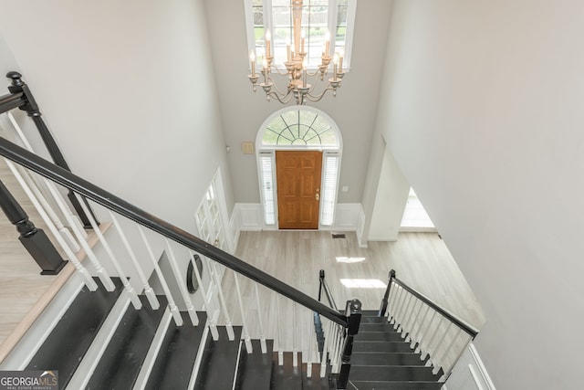2635 Stonehill Dr, Cumming, GA 30041 - entryway featuring a chandelier, plenty of natural light, a high ceiling, and stairs