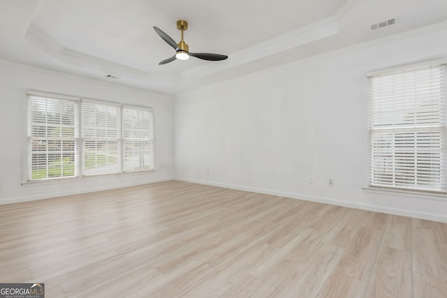 2635 Stonehill Dr, Cumming, GA 30041 - unfurnished room featuring a tray ceiling, light wood-style flooring, a ceiling fan, ornamental molding, and visible vents