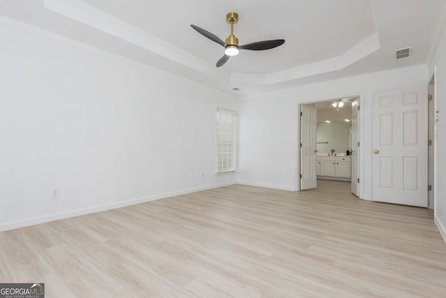2635 Stonehill Dr, Cumming, GA 30041 - unfurnished bedroom featuring crown molding, ensuite bathroom, a tray ceiling, light wood-type flooring, and visible vents