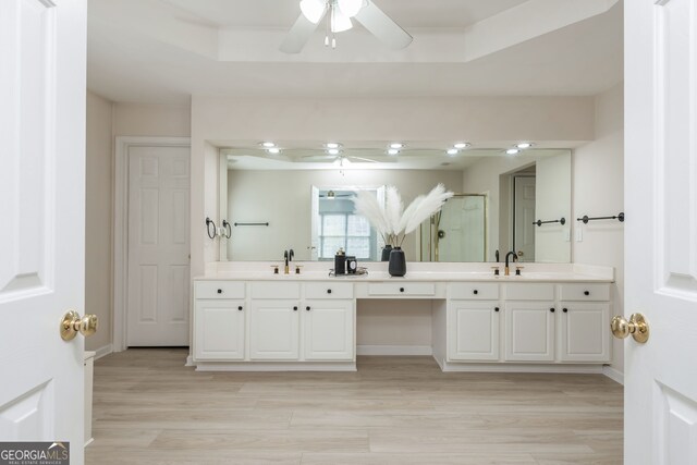 2635 Stonehill Dr, Cumming, GA 30041 - full bath with wood finished floors, double vanity, a sink, and ceiling fan