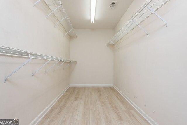 2635 Stonehill Dr, Cumming, GA 30041 - spacious closet with visible vents and wood finished floors