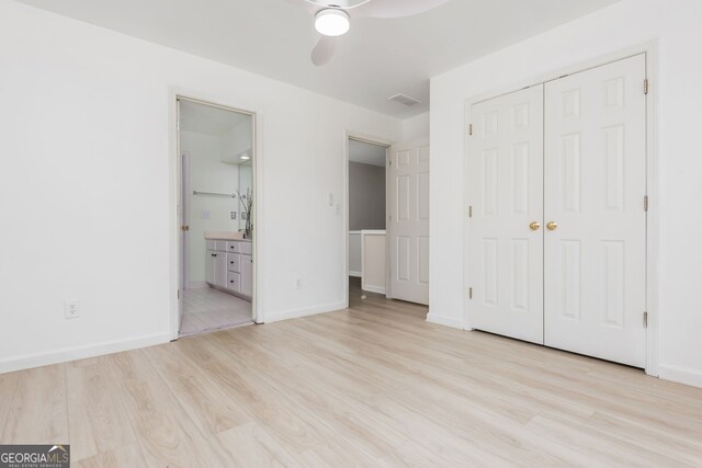 2635 Stonehill Dr, Cumming, GA 30041 - unfurnished bedroom with a closet, baseboards, connected bathroom, and wood finished floors