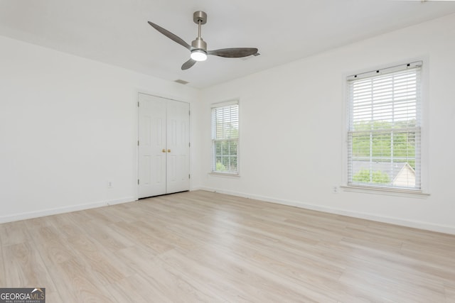 2635 Stonehill Dr, Cumming, GA 30041 - spare room with visible vents, light wood-style flooring, ceiling fan, and baseboards