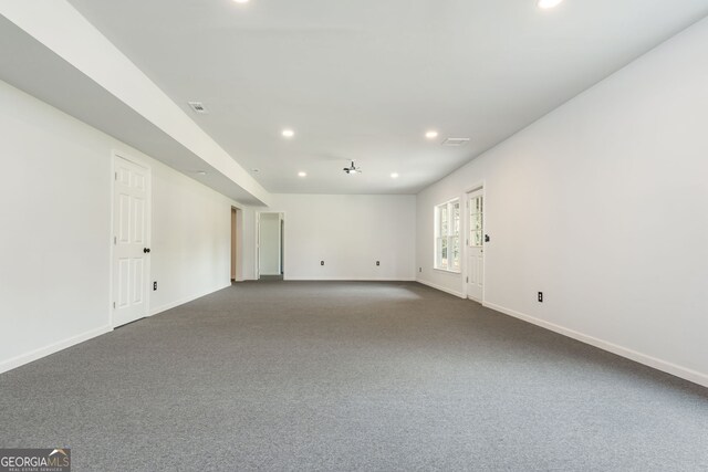 2635 Stonehill Dr, Cumming, GA 30041 - empty room with visible vents, dark colored carpet, baseboards, and recessed lighting