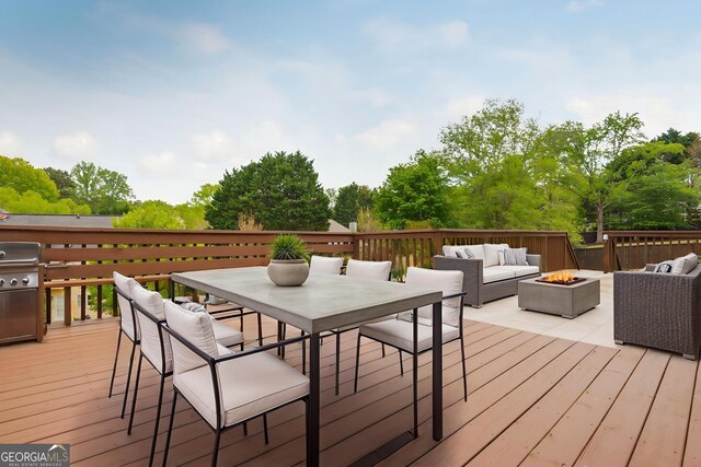 2635 Stonehill Dr, Cumming, GA 30041 - wooden deck featuring outdoor dining area and an outdoor living space with a fire pit