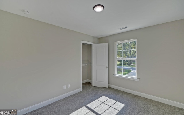 unfurnished bedroom featuring visible vents, baseboards, and carpet floors