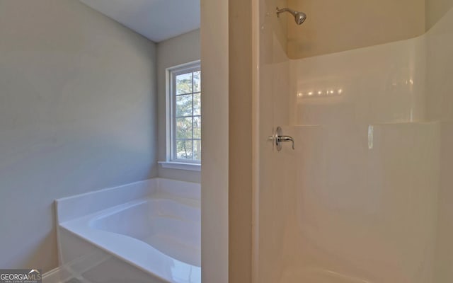 full bathroom with walk in shower and a bath
