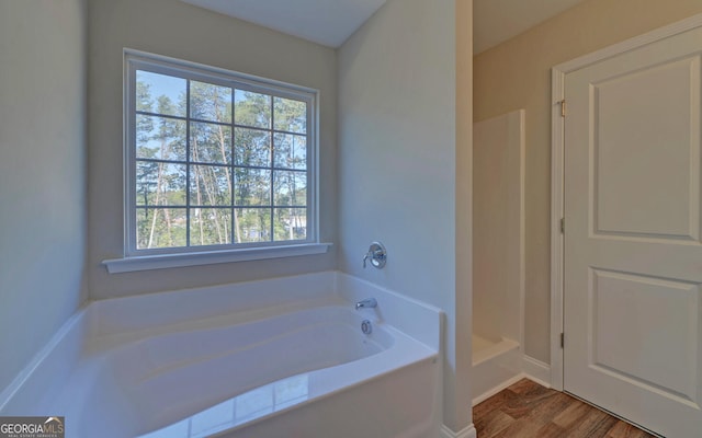 full bathroom with walk in shower, wood finished floors, and a bath