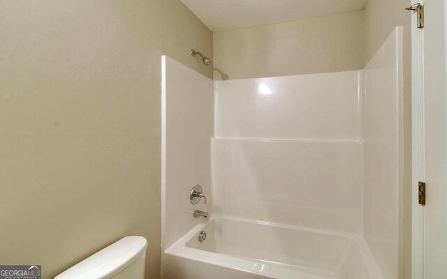 bathroom with shower / bath combination and toilet