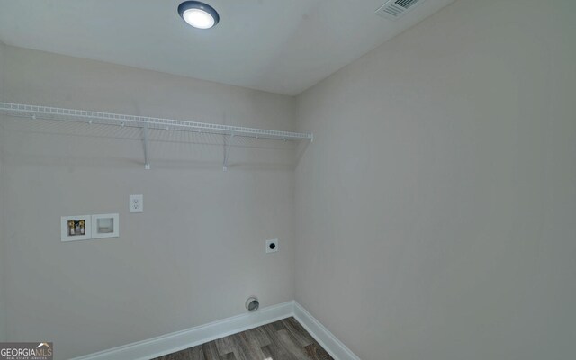 laundry room with hookup for an electric dryer, laundry area, dark wood-style flooring, visible vents, and baseboards