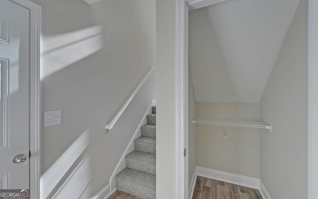stairs with baseboards and wood finished floors