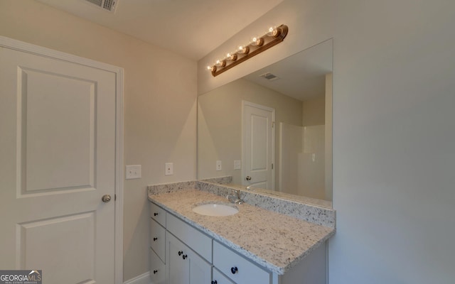 bathroom with visible vents, baseboards, and vanity
