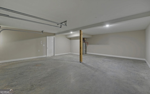 garage featuring water heater and baseboards