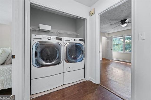 clothes washing area featuring baseboards, separate washer and dryer, a ceiling fan, laundry area, and dark wood-type flooring