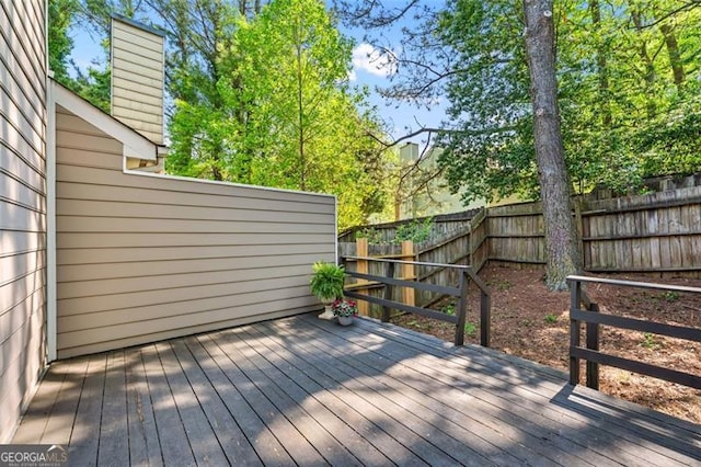 deck with a fenced backyard