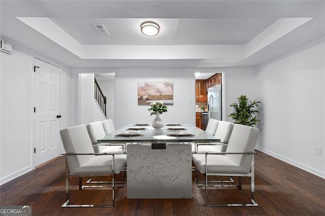 dining room with stairway, visible vents, baseboards, and a raised ceiling