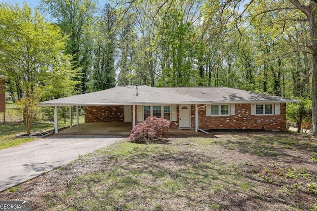 1093 Lanier Dr SW, Marietta, GA 30060 - ranch-style house featuring a carport, brick siding, and driveway