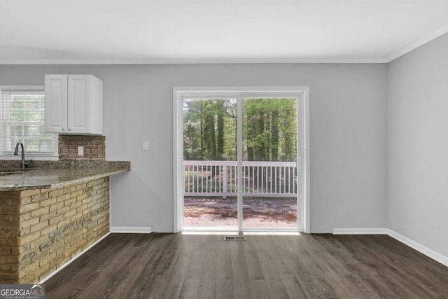 1093 Lanier Dr SW, Marietta, GA 30060 - unfurnished dining area with baseboards, ornamental molding, and plenty of natural light
