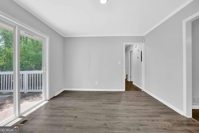1093 Lanier Dr SW, Marietta, GA 30060 - spare room featuring dark wood-type flooring, ornamental molding, and visible vents